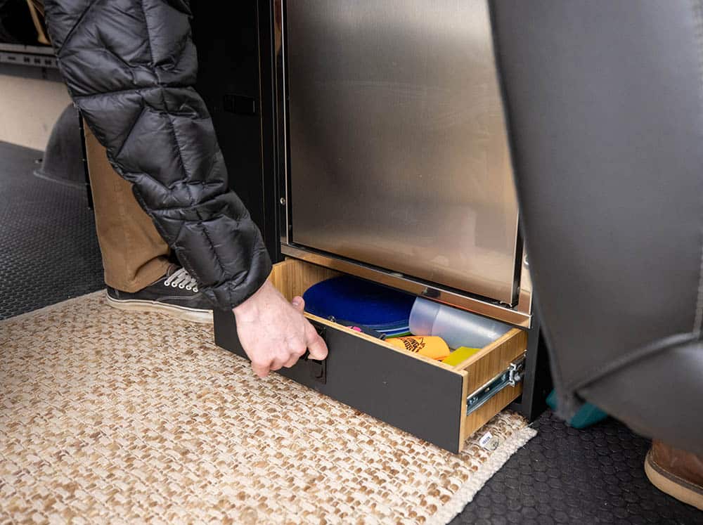Man opening camper van galley drawer