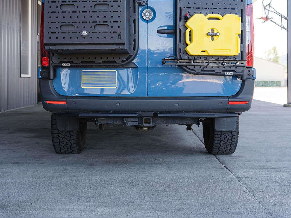 Rear facing view of Sprinter Van Rear Plate Step installed with factory bumper