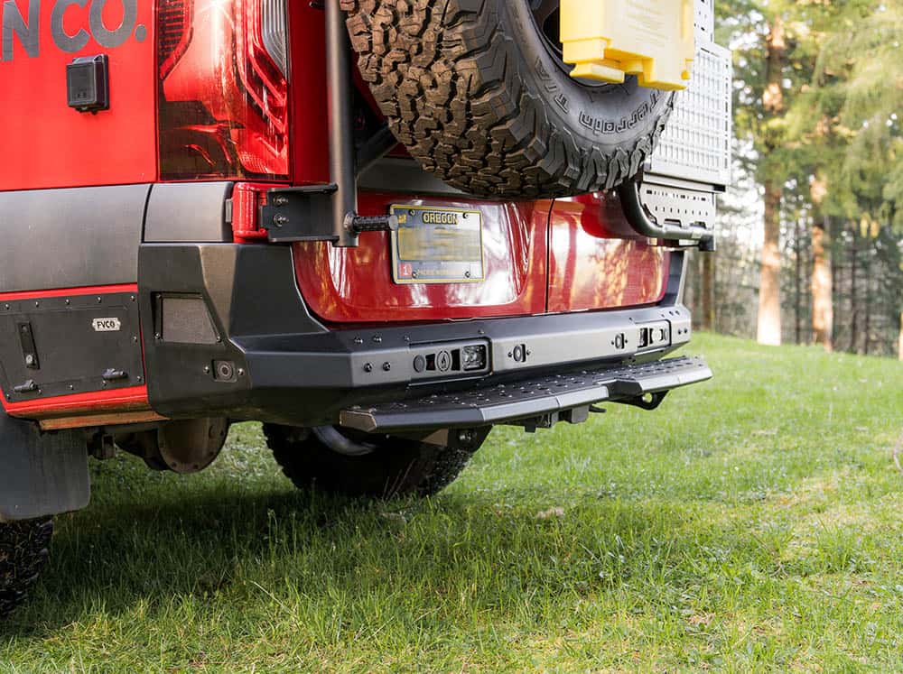 Mercedes Sprinter camper van with rear plate step in the woods