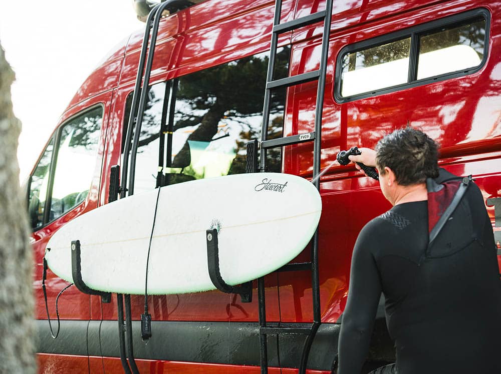Surfboard in surf hooks getting sprayed off