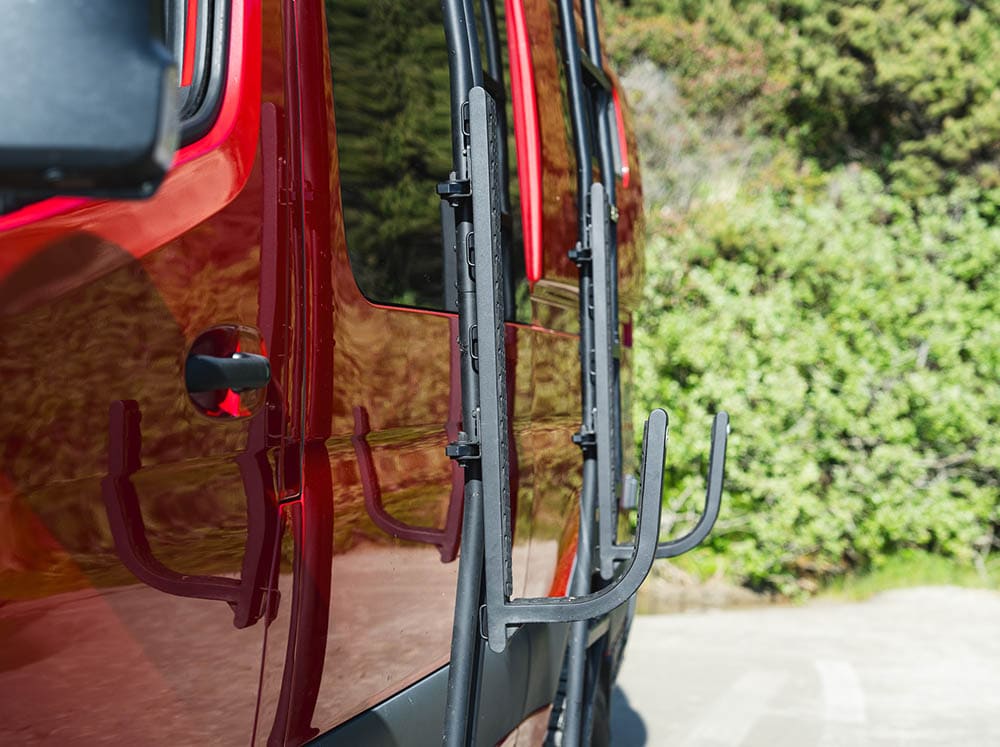 Side view of universal surf hooks on camper van