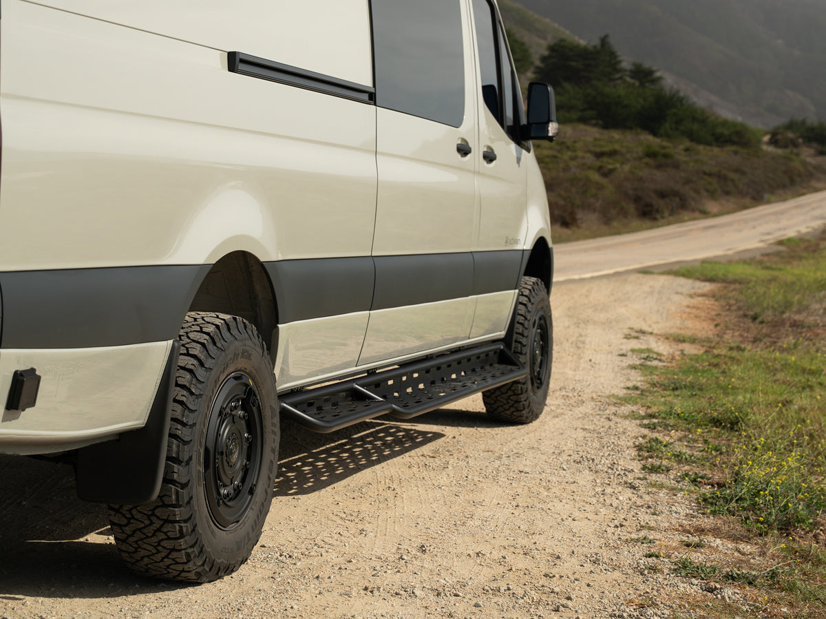 Sprinter aluminum side steps installed on van parked on side of road 