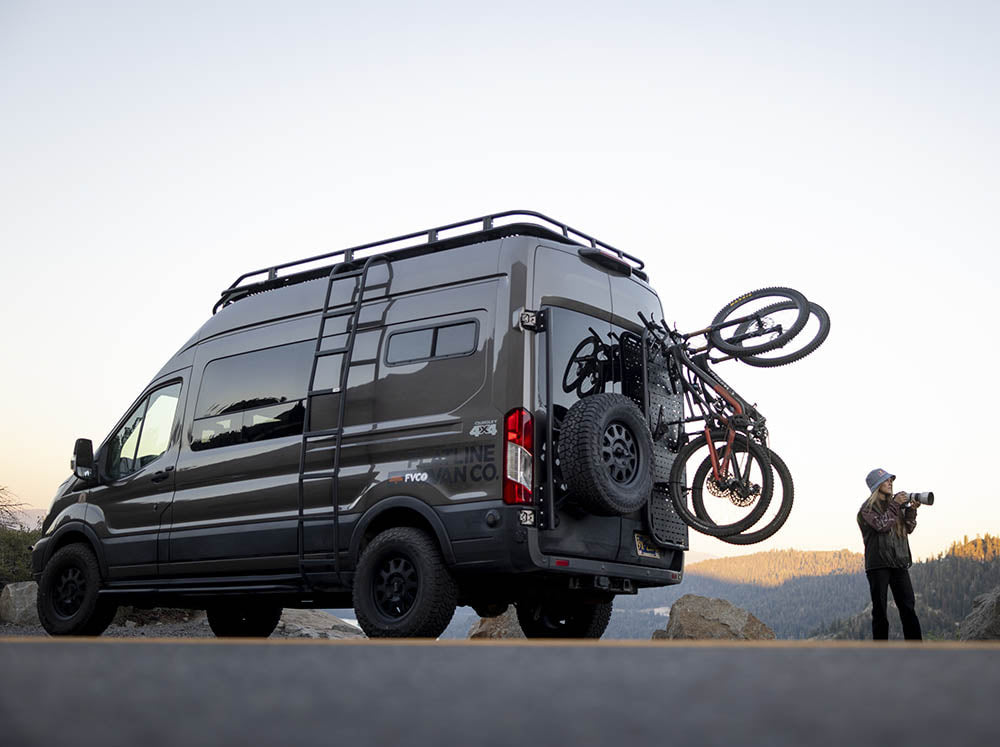 Fully loaded Transit adventure van on a biking trip with photographers