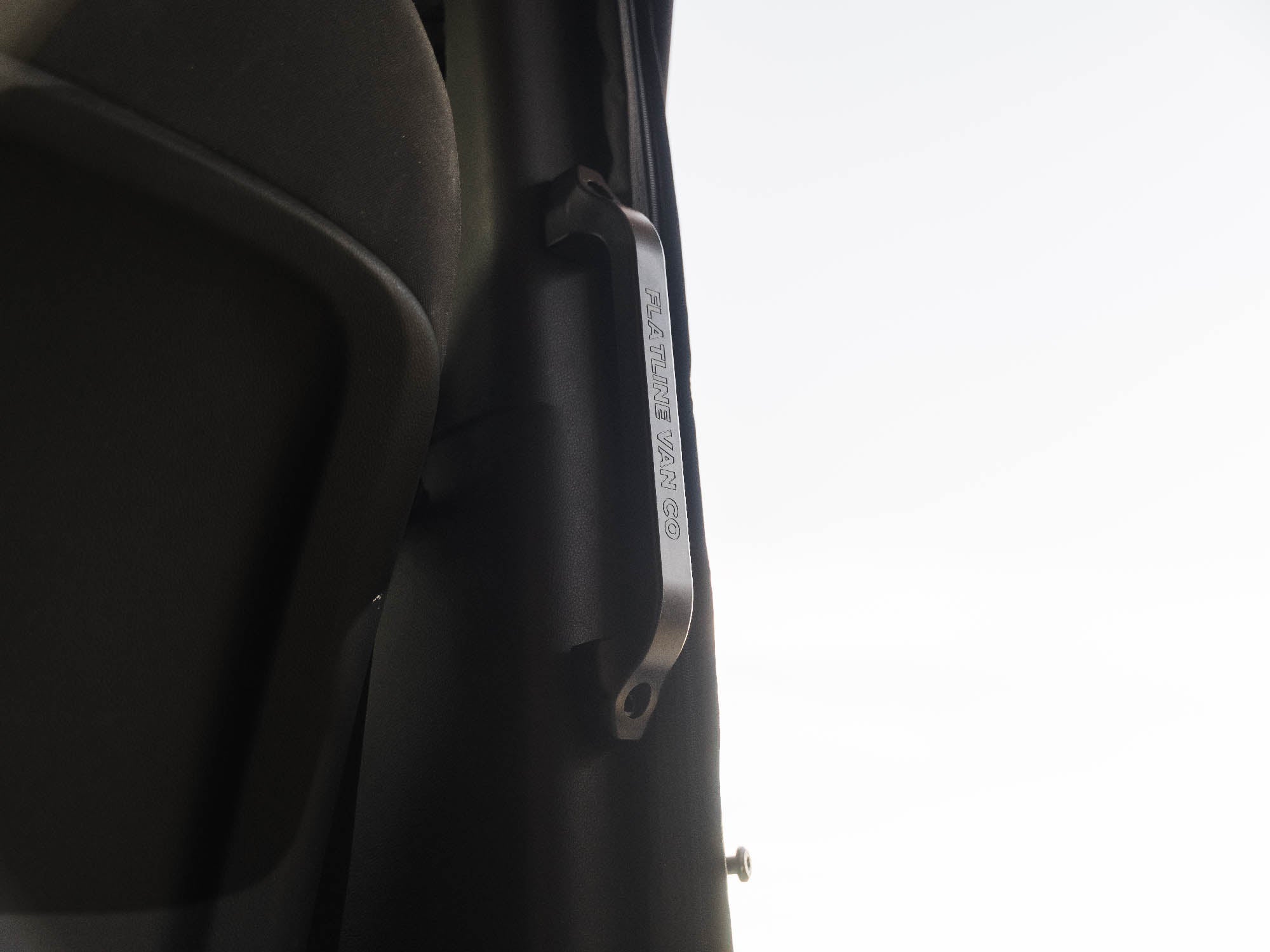 Low angle view of Sprinter Slider Grab Handle with black/machined logo imprint installed in van