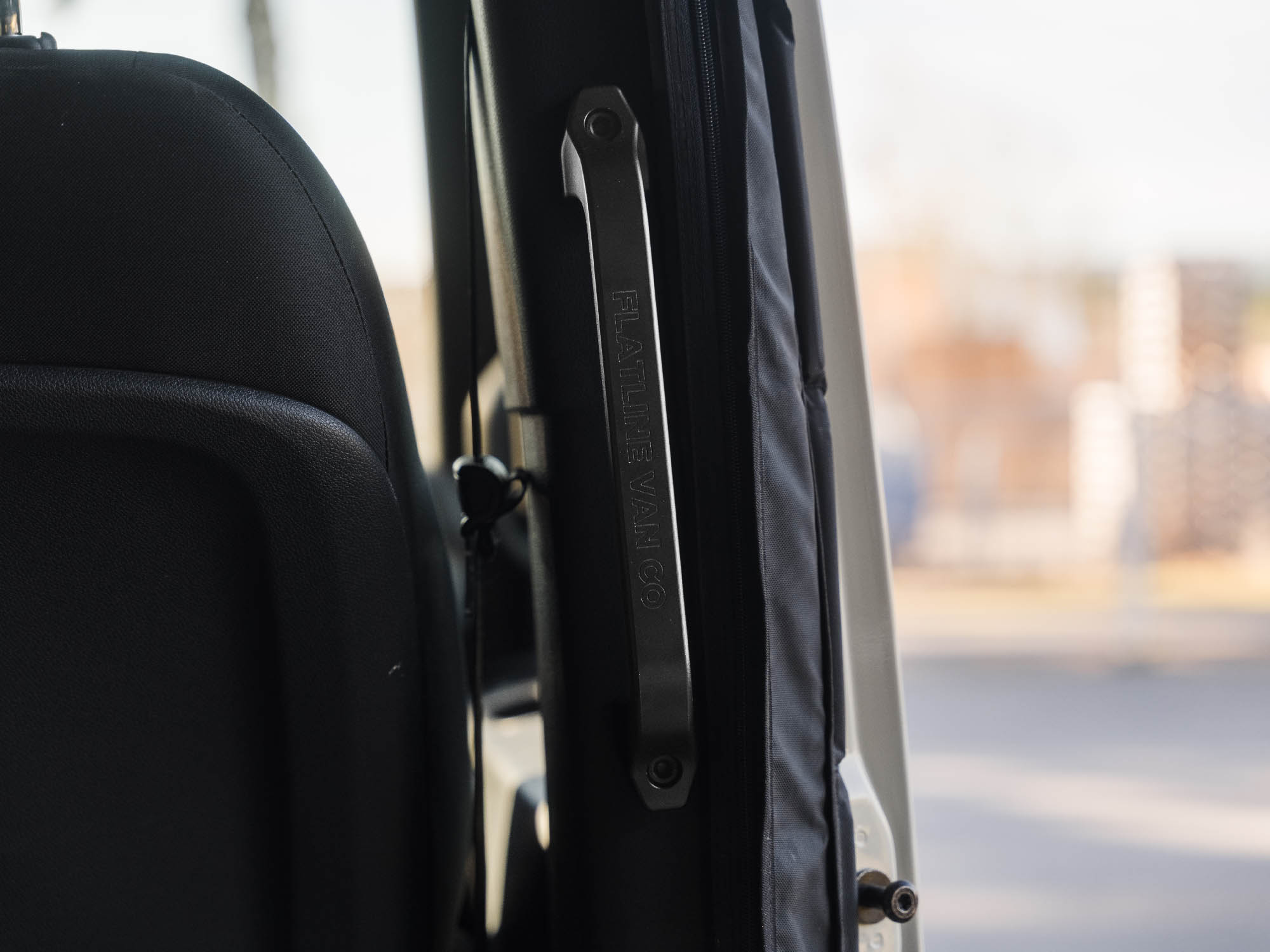 Front view of installed Sprinter Slider Grab Handle with black machined logo