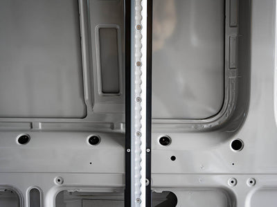 Close-up view of Sprinter Van Bed Bracket L-Track Kit installed on Sprinter Bed Brackets in 144" high roof Sprinter camper van