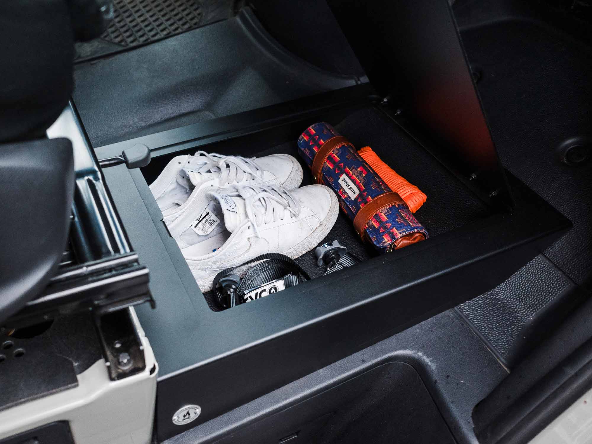 Items stored inside Sprinter Van Passenger Floor Riser Compartment for 2019+ Mercedes-Benz Sprinter vans