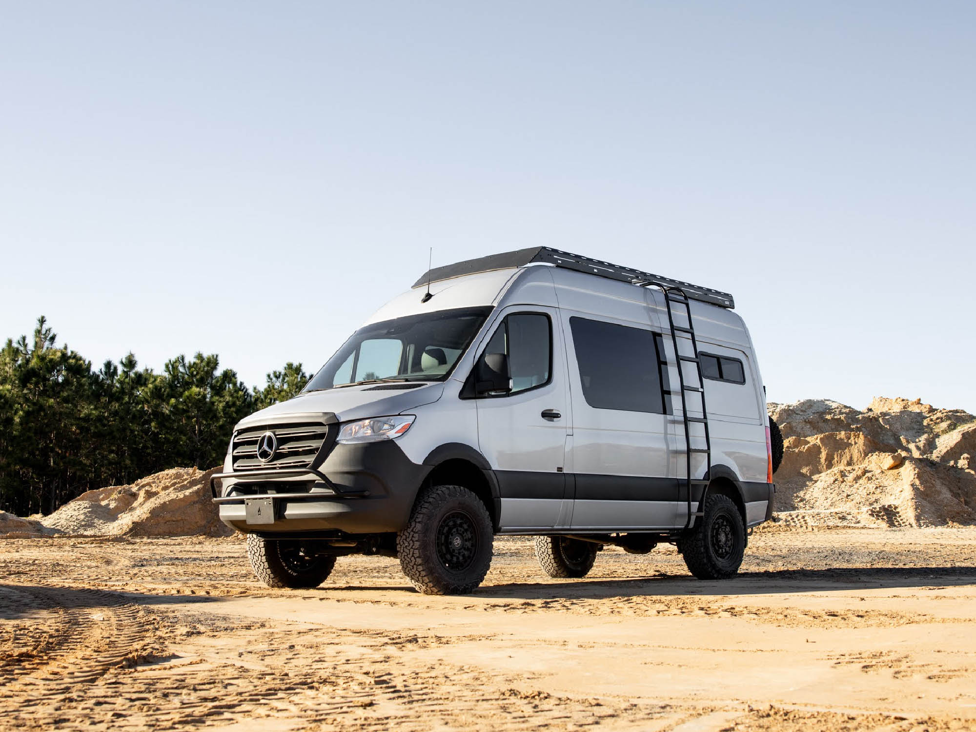 Sprinter camper van with Nudge Bar, Standard Roof Rack, and Wheel Wrap Side Ladder from Flatline Van Co.