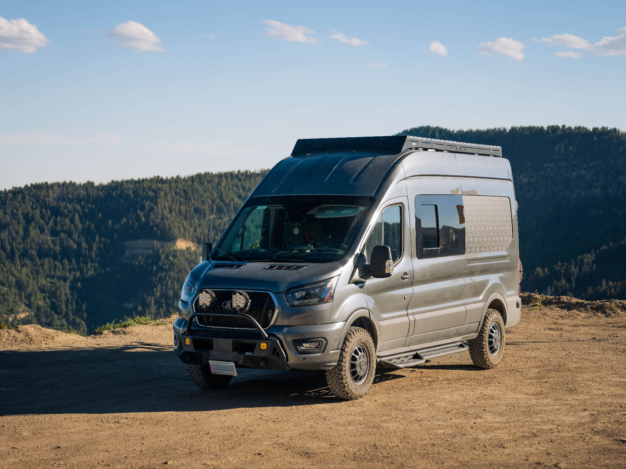 Transit Van Low Pro Roof Rack installed on 148 high roof model in scenic camping spot