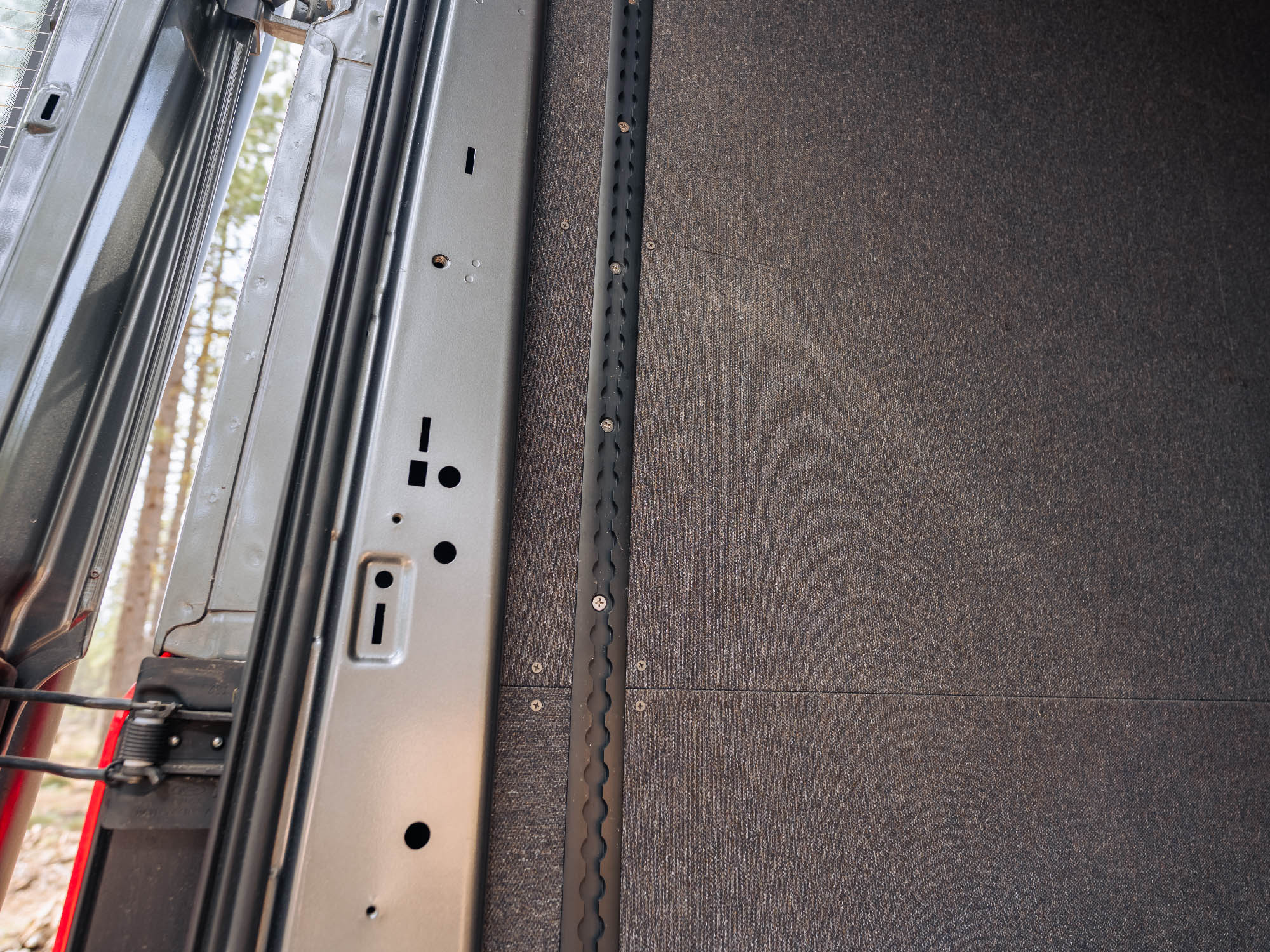Transit Bed Bracket Flush Mount L-Track installed in van with insulated walls