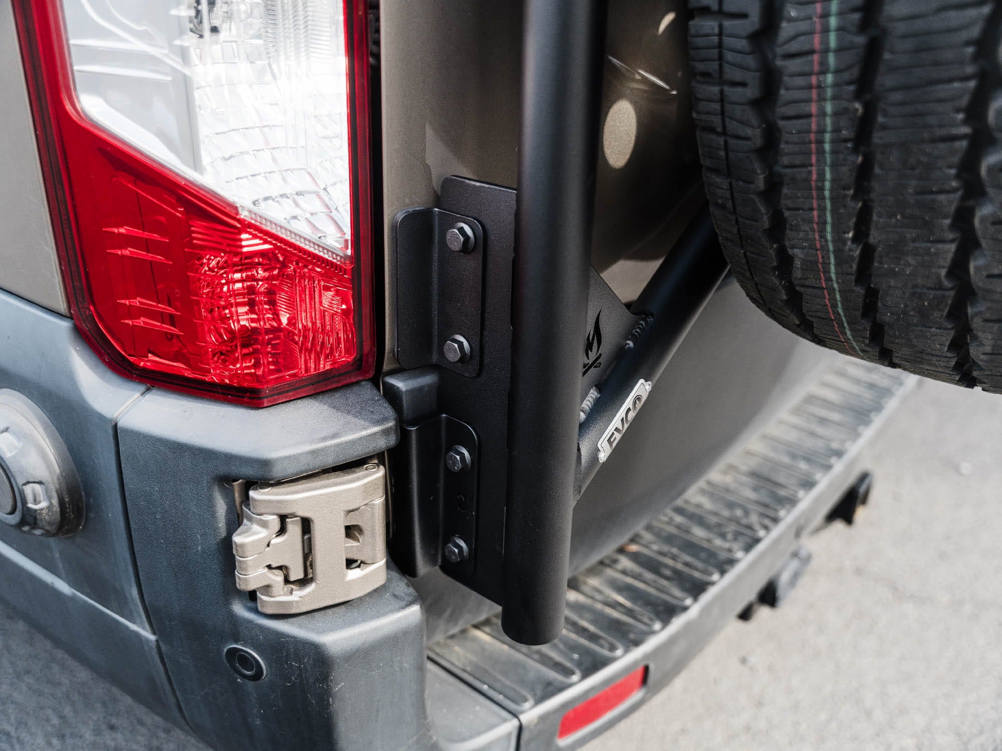 Close up view of lower mounting of installed Transit Tire Carrier