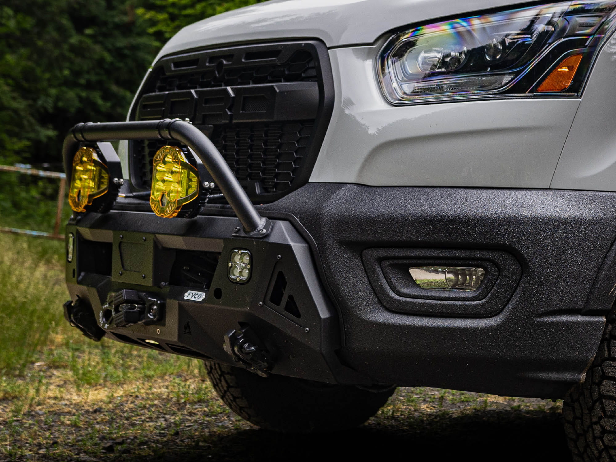 Close view of Transit Core Front Bumper installed with Bull Bar option and auxiliary off road lighting