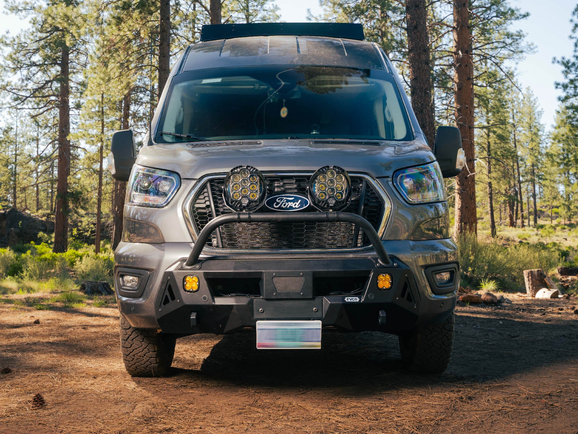 Ford Transit van with Transit Core Front Bumper parked at camp
