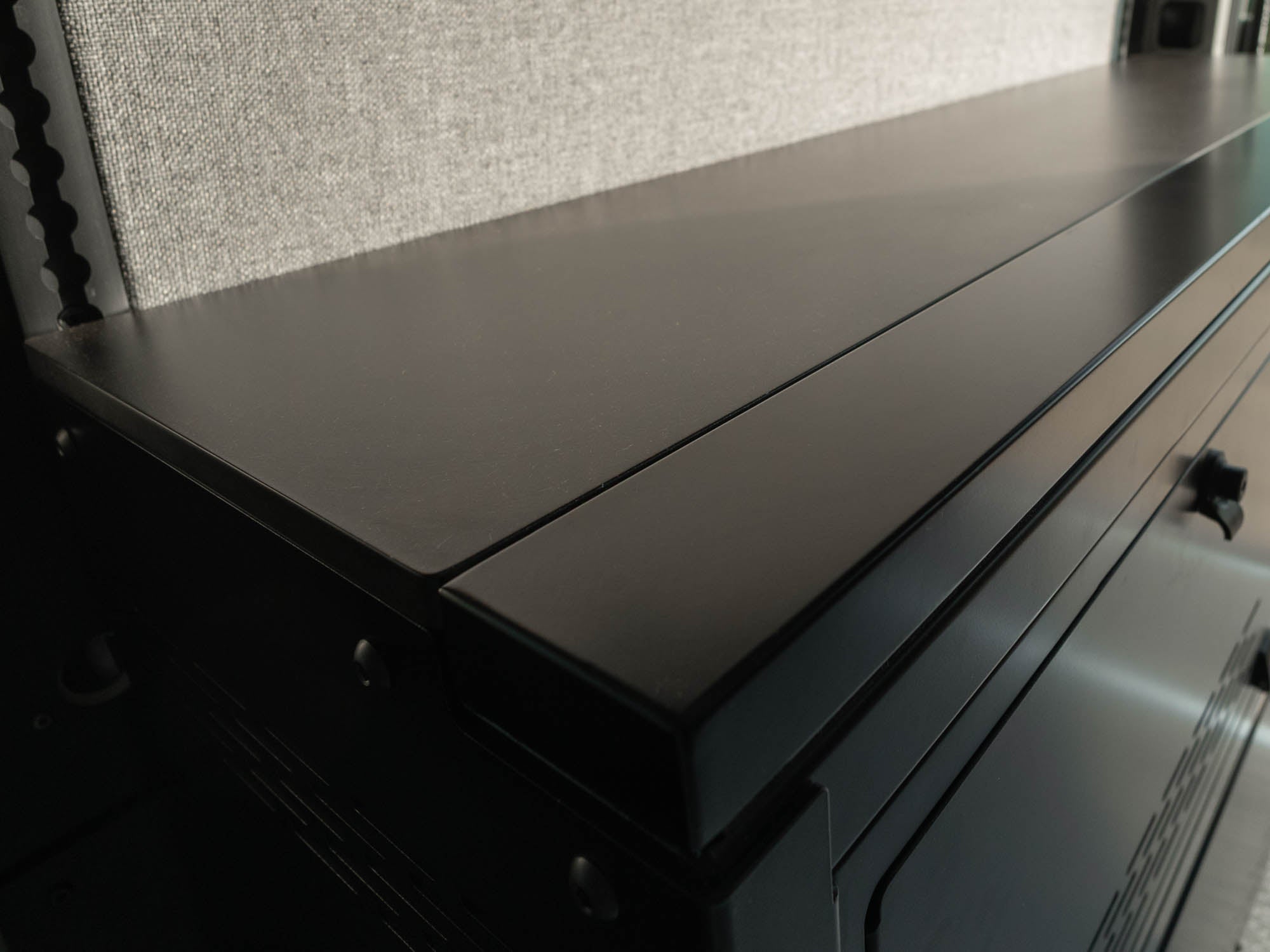 Close-up image of Modular Cabinet Bed System for Sprinter & Transit CGL counter top and removable front piece for when the bed is not in use