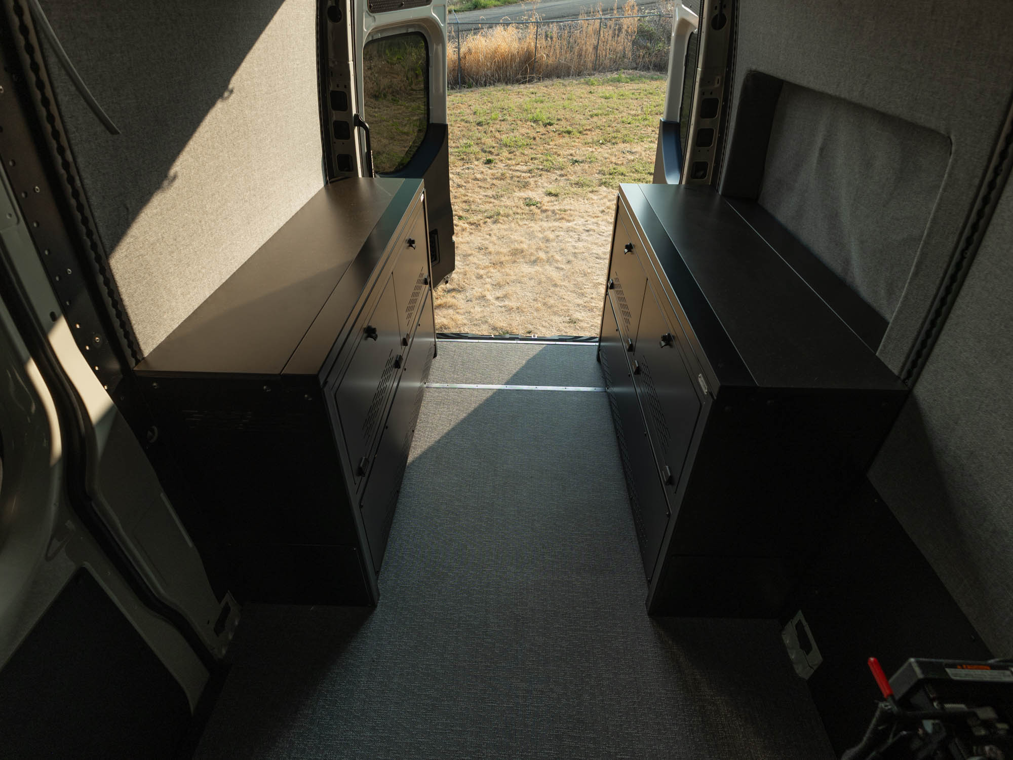 East-West Modular Cabinet Bed System for Sprinter & Transit with bed panels removed for two large countertops