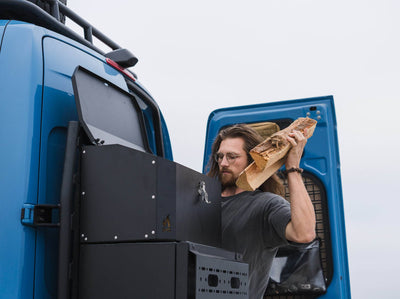 Person getting firewood out of Adventure Van Gear Box