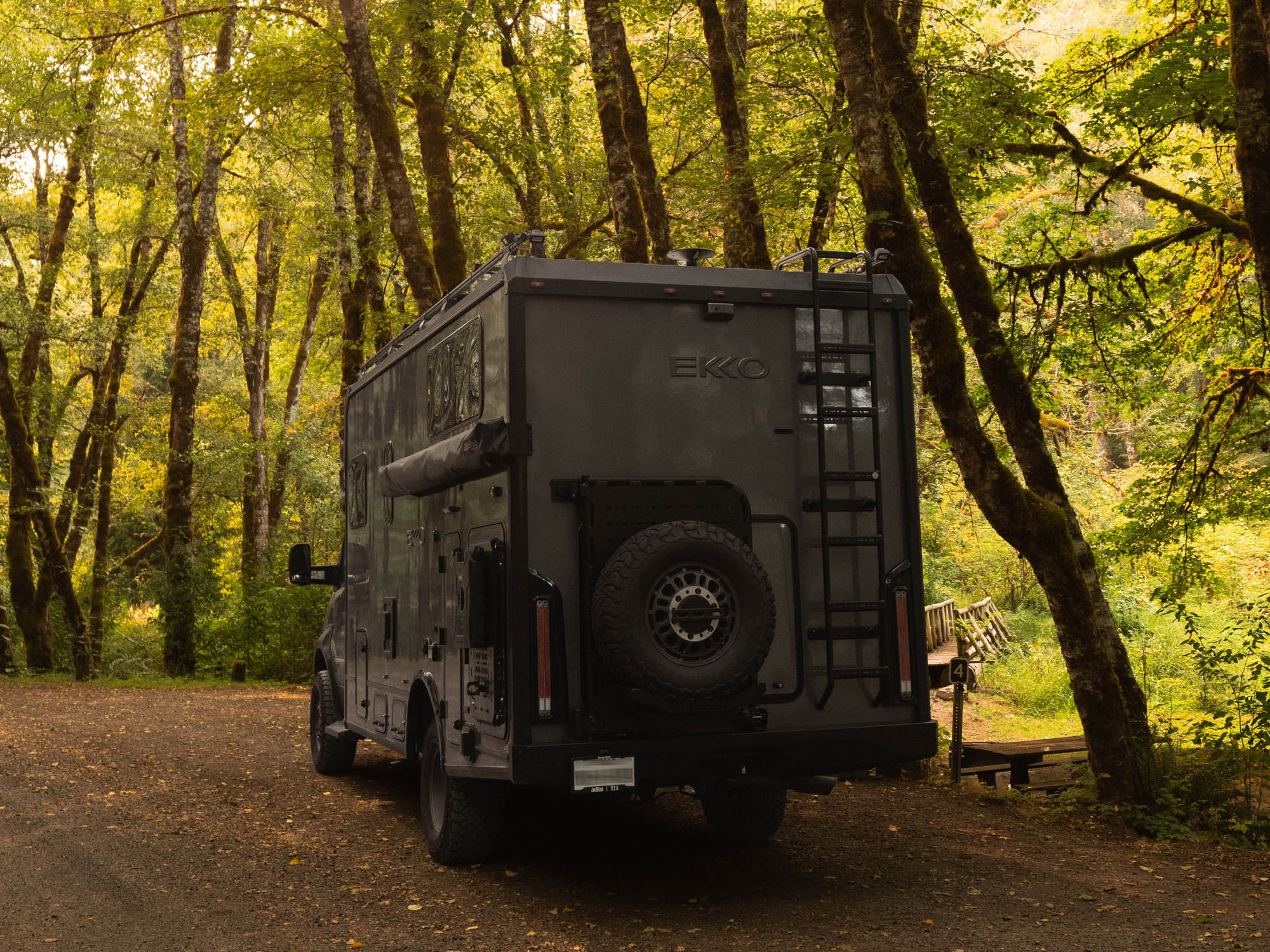 Winnebago Ekko Rear Bumper for Sprinter and Transit vans installed on rig driving in the woods