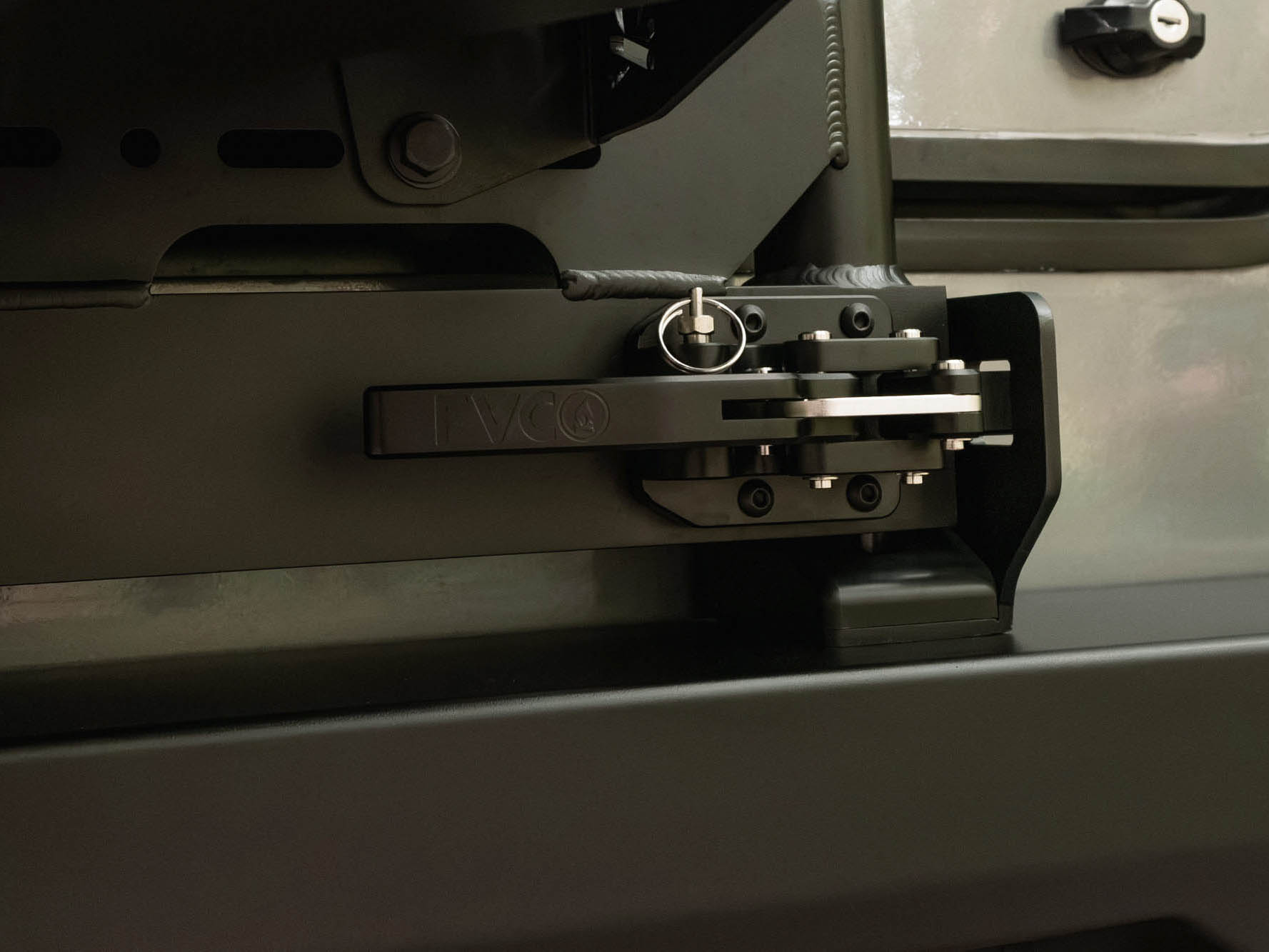 Close up view of Flatline Van Co cam latch designed in the USA
