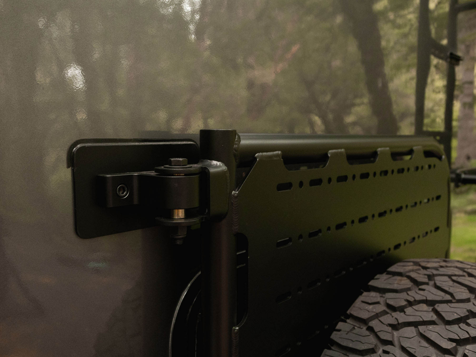 Detail view of Winnebago Ekko Rear Platform solid and secure mounting and upper pivot point 