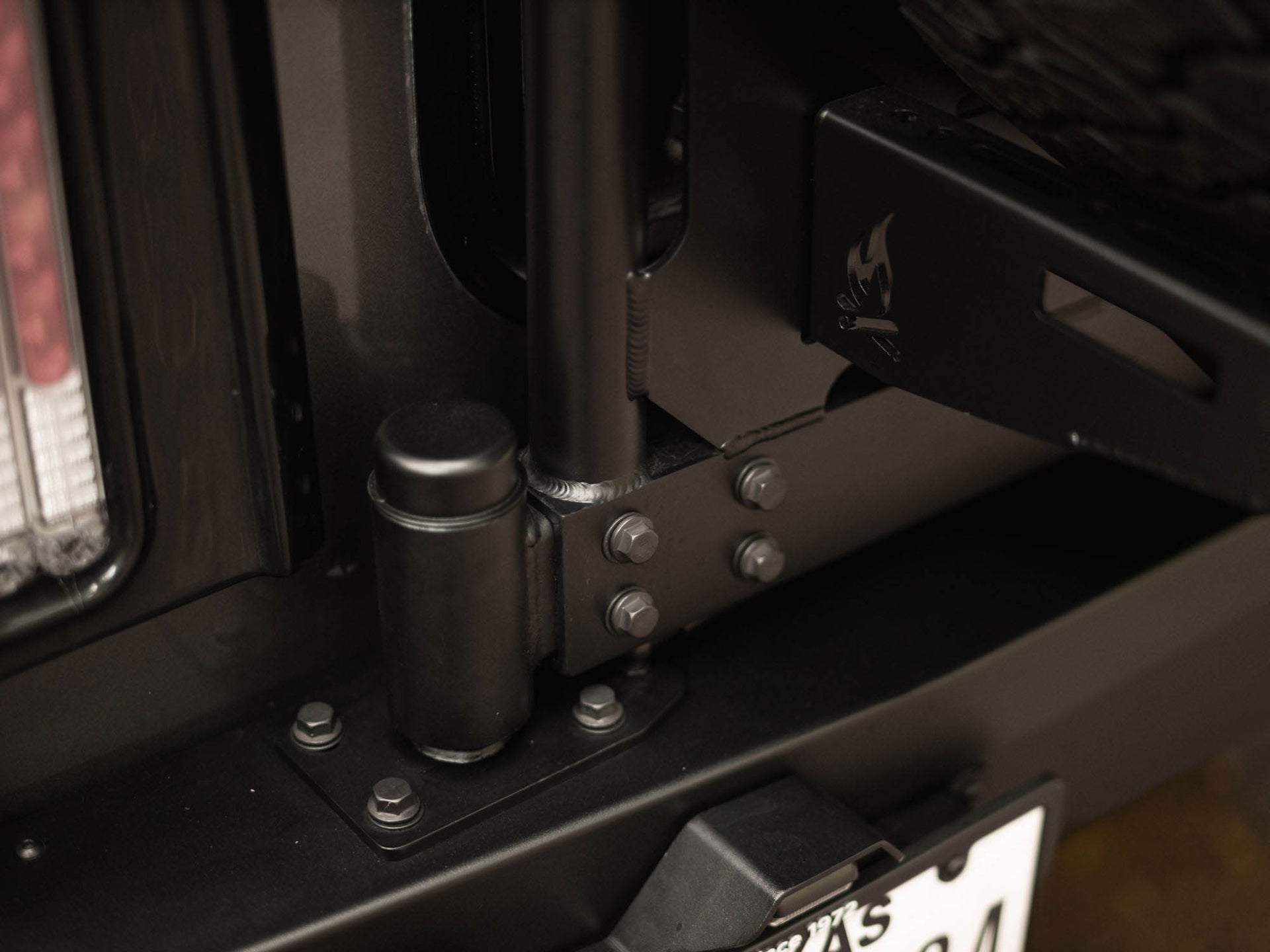Detail view of lower pivot point of the Winnebago Ekko Rear Platform installed to Rear Bumper