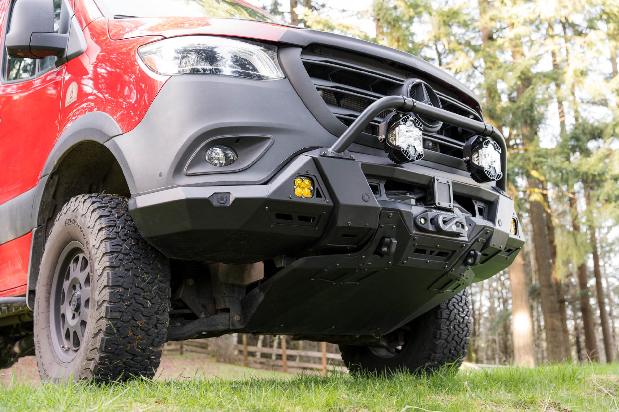 Low view of Sprinter Van Front Bumper by FVC with skid plate, bull bar, winch setup, and offroad lighting
