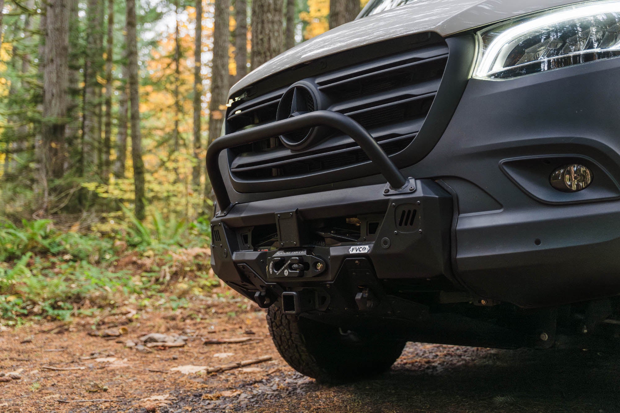 FVC Sprinter Core Front Bumper installed on camper van driving in the woods