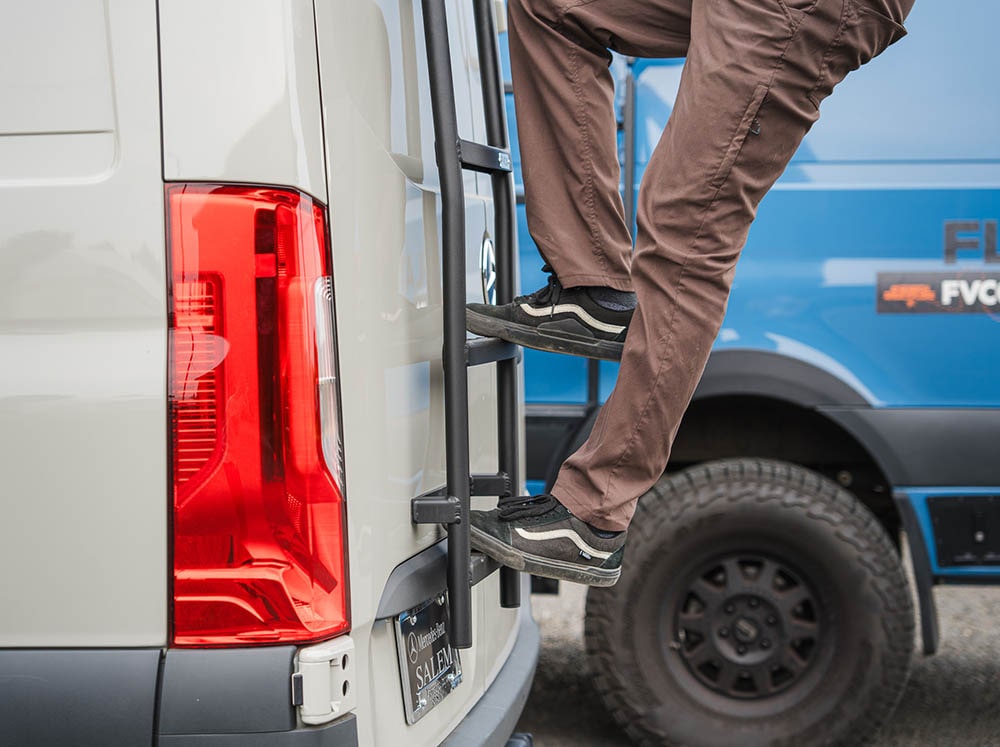 Person stepping on Sprinter Rear Ladder to access rooftop