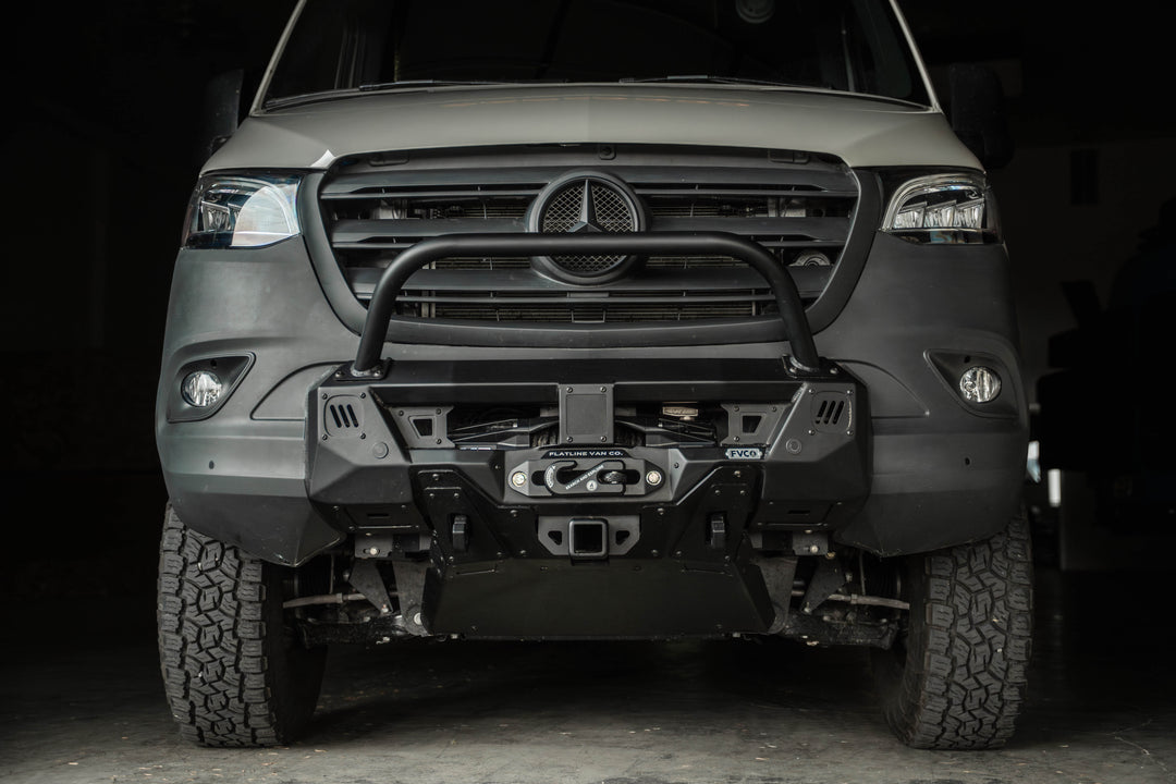 Front view of Sprinter Van Core Front Bumper by Flatline Van Co with bull bar, skid plate, winch, and front hitch receiver