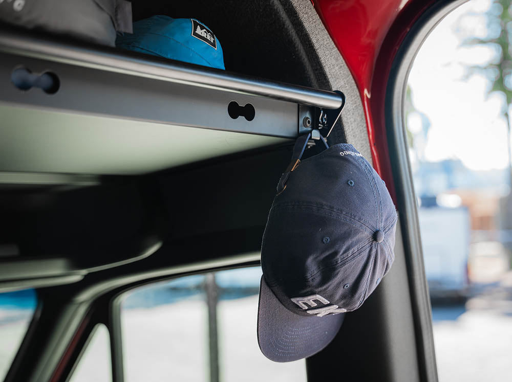 Hat hanging on hook of Sprinter Van Headliner Shelf Curtain Rod