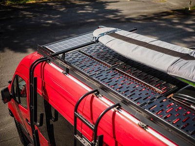 Adventure van with surfboard storage on the roof with high bars