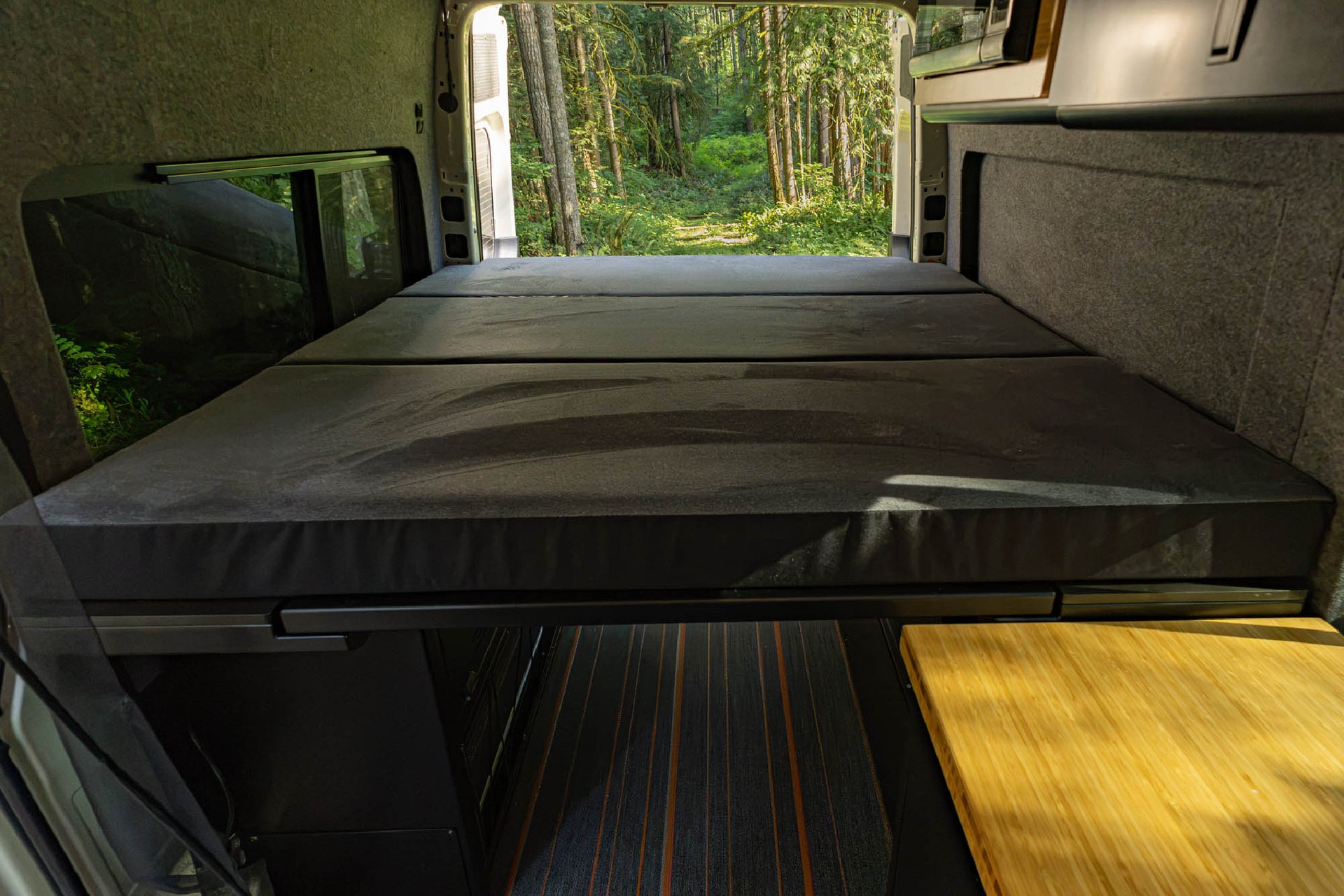 Foldable custom fit mattress installed with the Modular Bed Cabinet System for Sprinter & Transit 