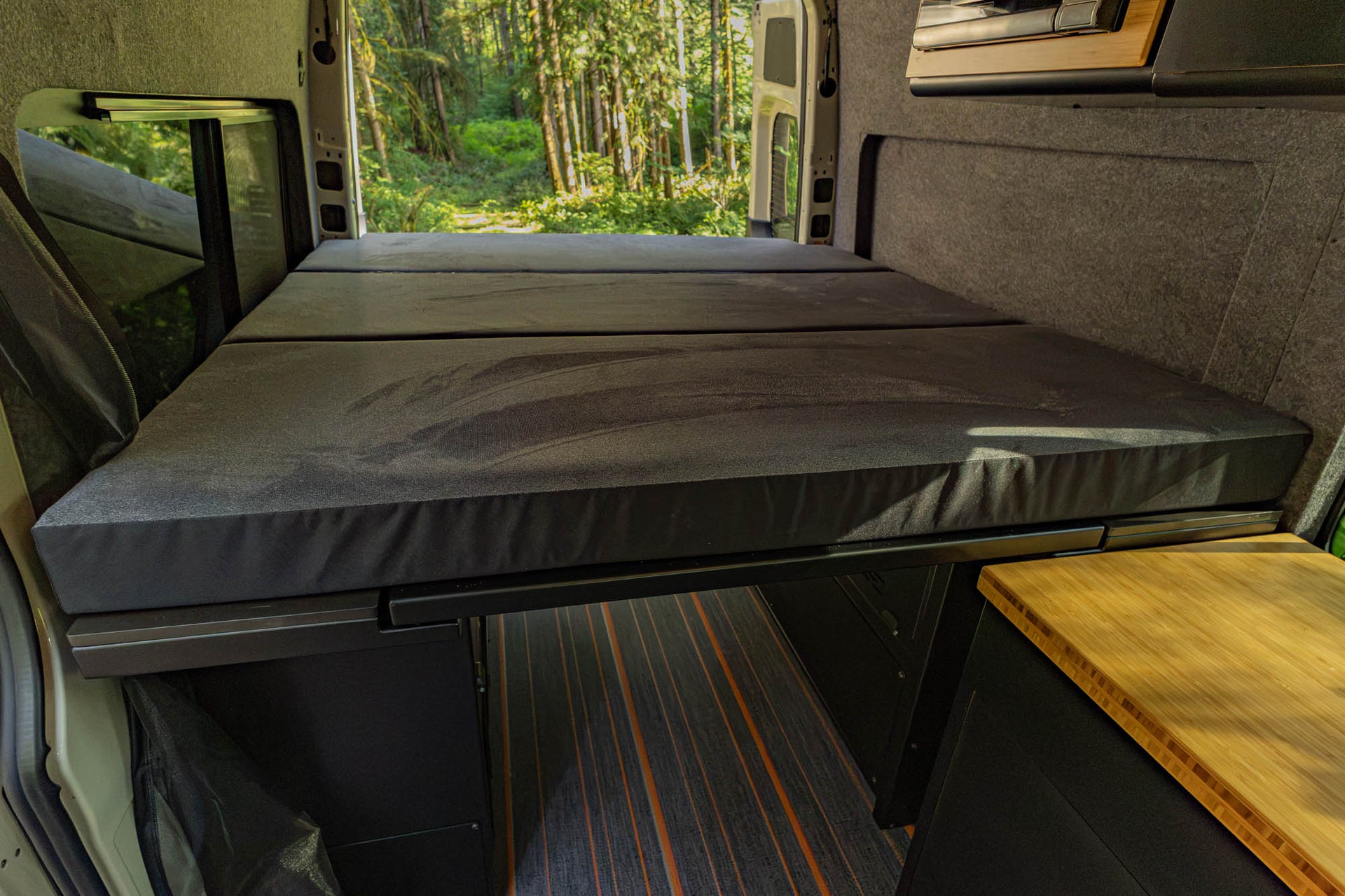 Custom fit mattress installed with the Modular Bed Cabinet System for Sprinter & Transit offered in Medium-Firm or Soft firmness options