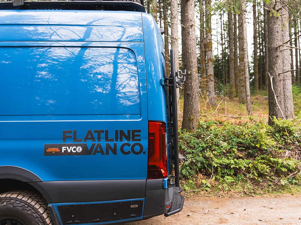 Side profile view of Sprinter Van Rear Door Platform installed on camper van in the woods