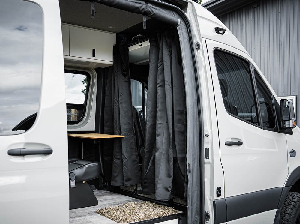 Blackout curtain installed on Curtain Rod for Sprinter Headliner Shelf