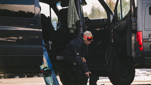 Travis Rice putting on Snowboard Gear in Sprinter Van