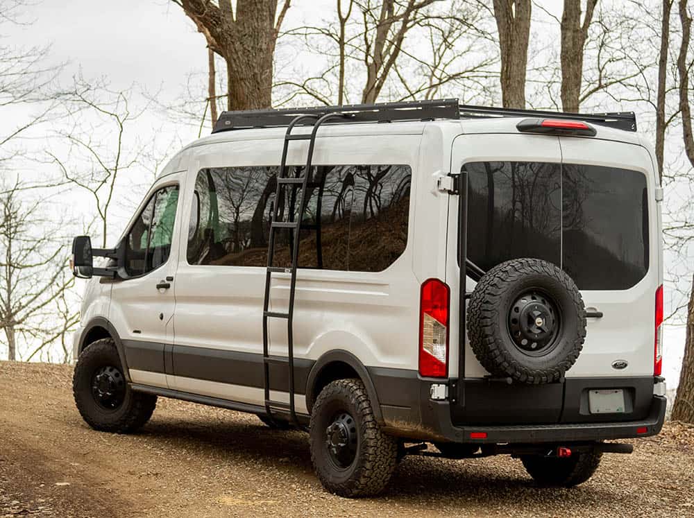 Rear angle of Transit Mid Roof Low Pro Roof Rack Installed on white Transit van