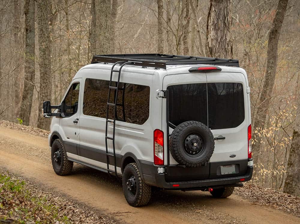 High-rear angle view of Transit Mid Roof Low Pro Roof Rack Installed on white Transit van